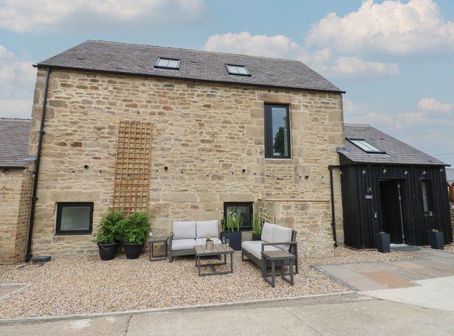An outdoor space with furniture and plants at Marcus Barn 3 Ebchester