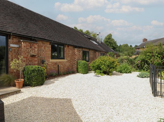 A brick house with a gravel garden and shrubs at Brookley Barn in Windley near Duffield