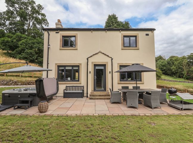 An outdoor area with a patio and furniture at Wood Cottage in Winterburn
