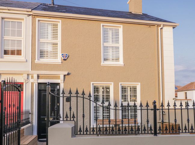 An exterior view of a house with a black door and windows at 41 Church view Portstewart