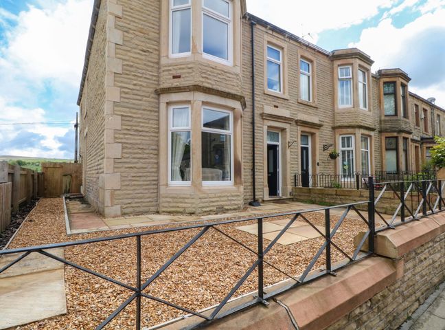 A house with a garden and pathway at 163 Manchester Road in Accrington
