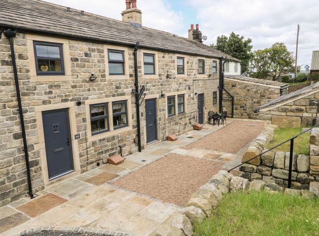 An outdoor area with stone cottage and pathway at Moss Cottage in Cragg Vale