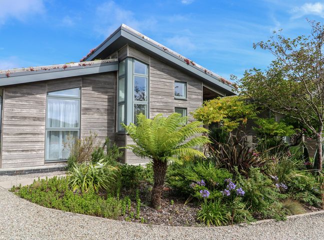 A house with large windows and a garden at Una, Lodge 70 Carbis Bay