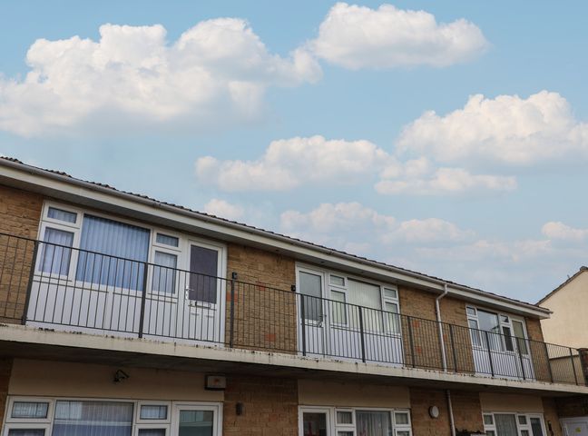 An exterior view of a multi-story building with balconies at Flat 8 Burnham-on-Sea