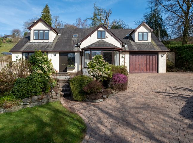A house with a garage and garden at Marina View Bowness-On-Windermere