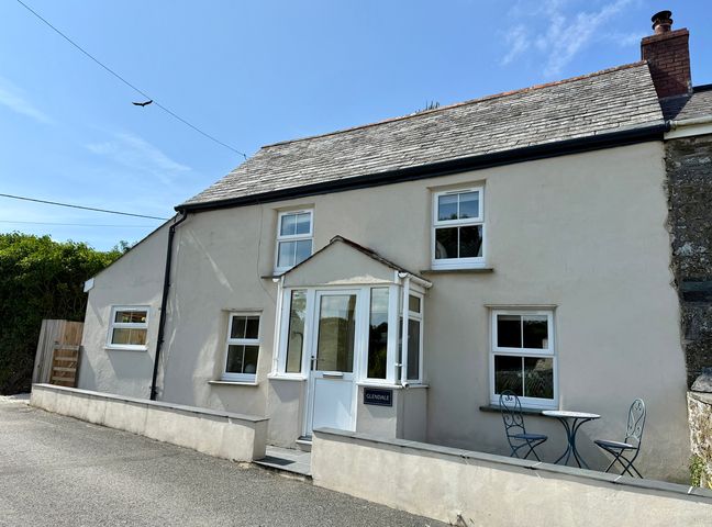 A house with a front porch and seating area at Glendale Trelights near Port Isaac