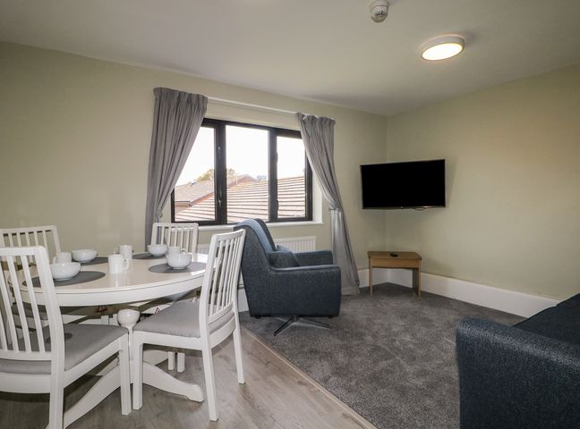 A living room with a dining table and sofa at Flat 1 in Littlehampton