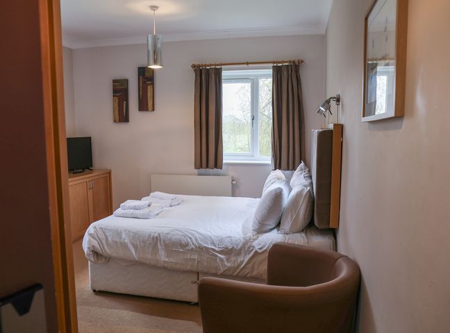 A bedroom with a bed and television at Bedroom 21 Penrith