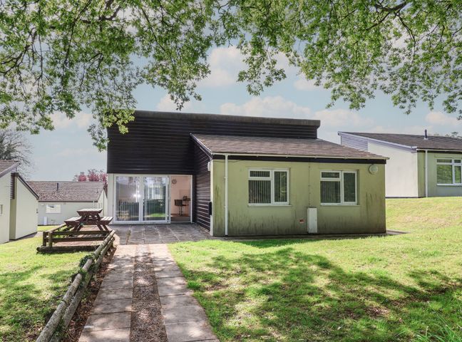 A house with a patio and outdoor seating area at The Stag’s Hollow in Chudleigh