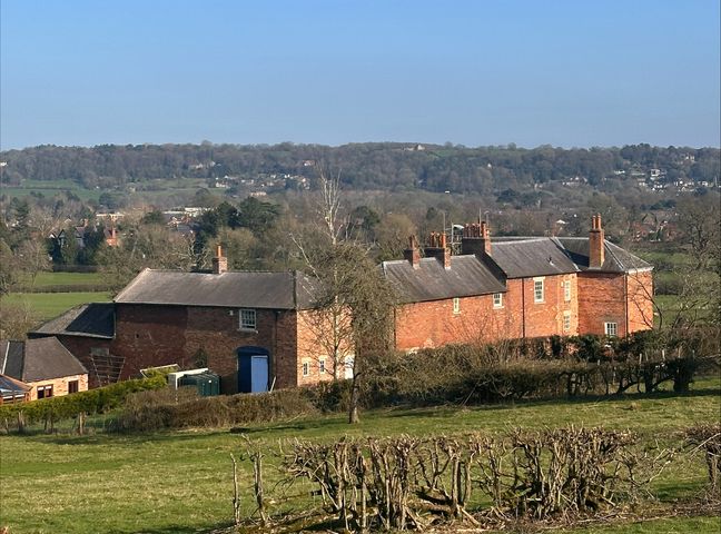 A brick building with a garden and a landscape view at Farnah House Barn in Duffield