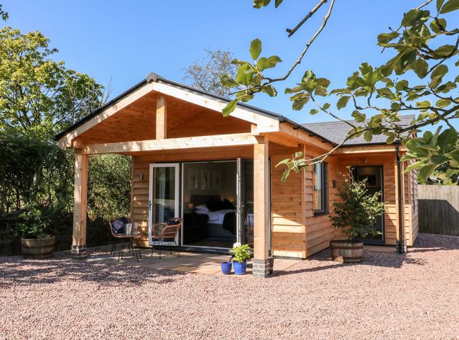 A house with a porch and garden furniture at The Lodge at Middleton House Stoke-on-Trent