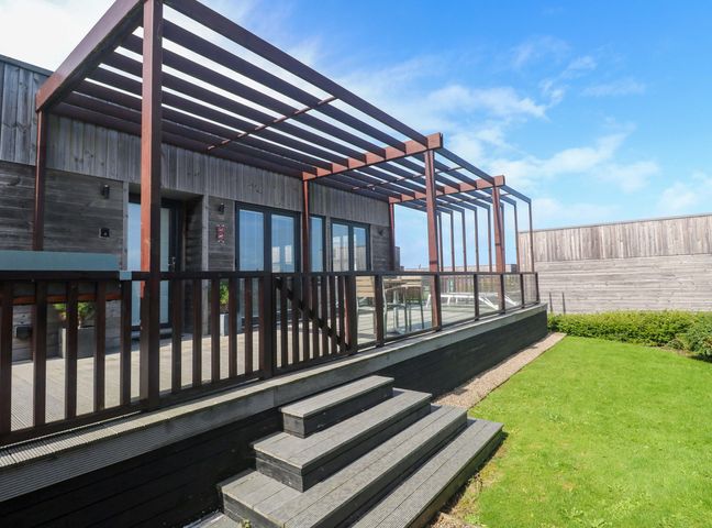 An outdoor area with a deck and stairs at Lodge 83, Gwel an Mor Portreath