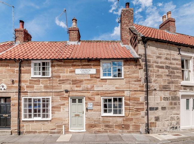 A building with windows and door on Church Street at Chimes Cottage in Guisborough