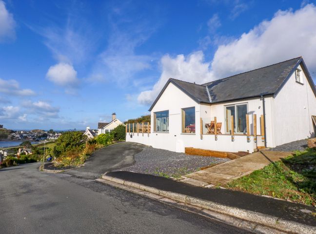 A house with a deck and chairs at Gowan Brae in Criccieth
