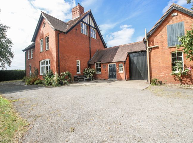 A house with a garage and driveway at The Old Vicarage Kimbolton near Leominster