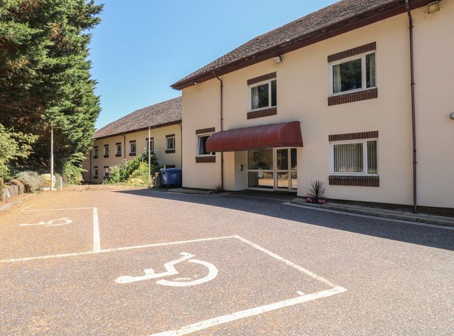 A building entrance with a parking lot at Sycamore in Newton Abbot