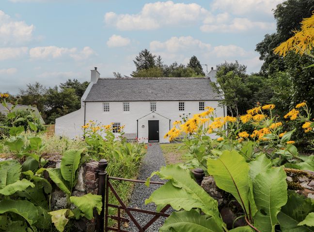 A house with a pathway and flowers at Sron Dubh in Achnasheen