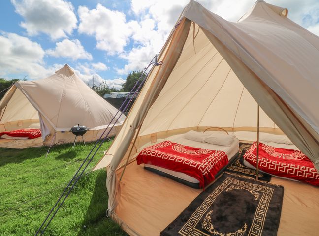 A tent with beds and blankets at Bell Tent Two