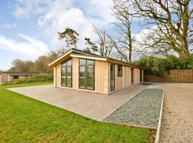 A house with large windows and a patio in Brayton, Aspatria