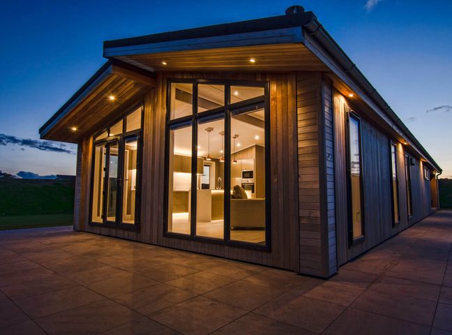An exterior view of a modern house with large windows at Darwin Retreat in Wigton