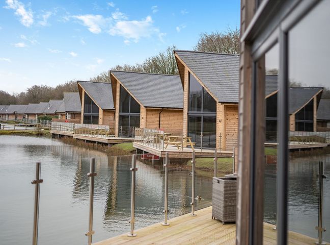 Cabins by a lake with deck and railings at Tranquillity 3 Warton near Carnforth