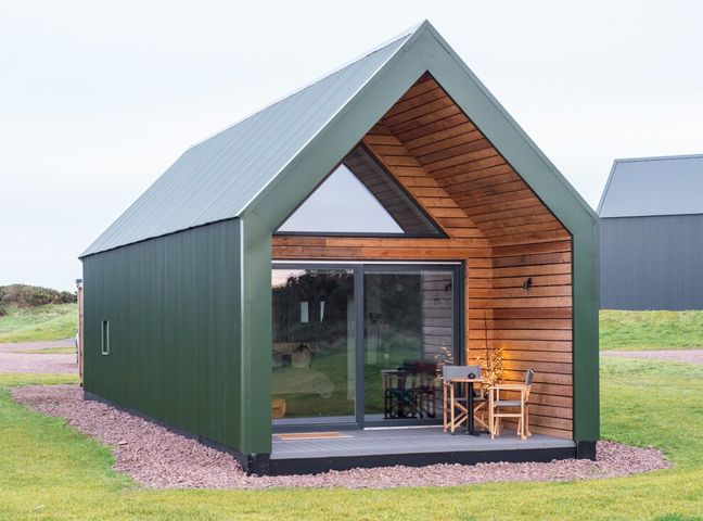 A cabin with a deck and table outside at The Weir in North Berwick
