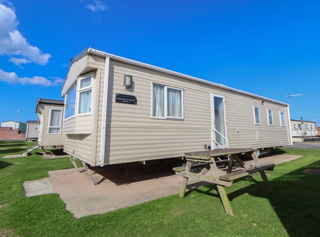A static caravan with a picnic table outside at A5 Static Caravan Rhyl