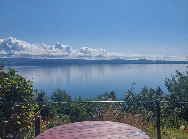 A view of a lake and sky with clouds at an outdoor location