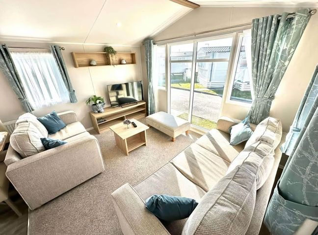 A living room with a TV and a coffee table at The Old Barn in Manchester