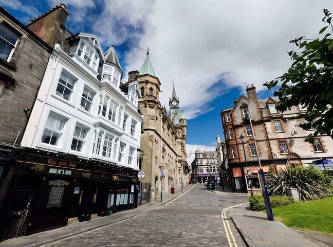 A street view with buildings and a clock tower at 15D Kirkgate
