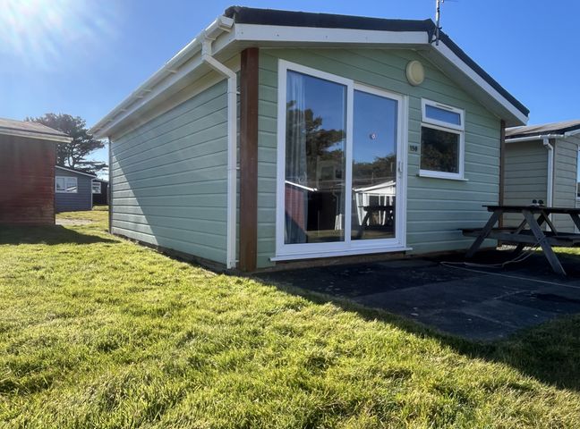An outdoor view of a bungalow with a table at Embury in 