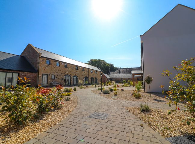 An outdoor area with buildings and a pathway at The Galloway in Morpeth