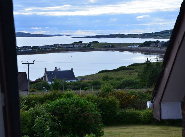 A view of houses and water from the garden at Oran Na Mara in Achnasheen