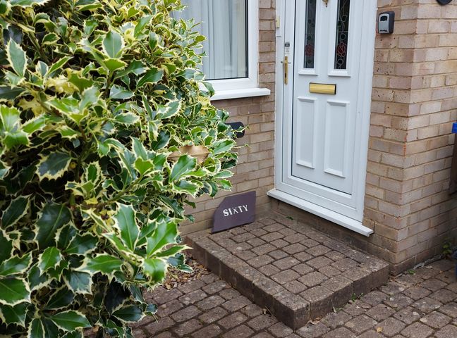An entrance with a front door and a welcome mat at 60 Pond Bank Northampton