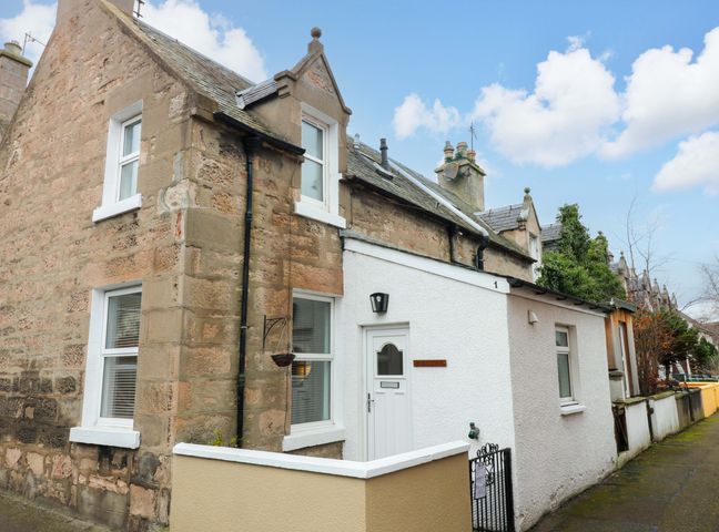 A house with windows and a door at Rose Cottage in Nairn