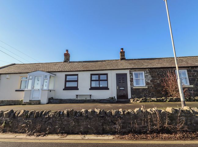 A house with multiple windows and a door at 2 Sunny Brae Embleton