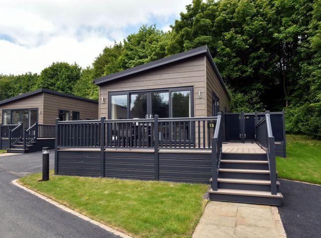A cabin with a deck and steps at The Falls (Pet) Leyburn