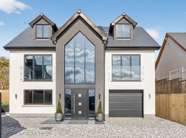 A house with large windows and a garage at Heddfan in Carmarthen