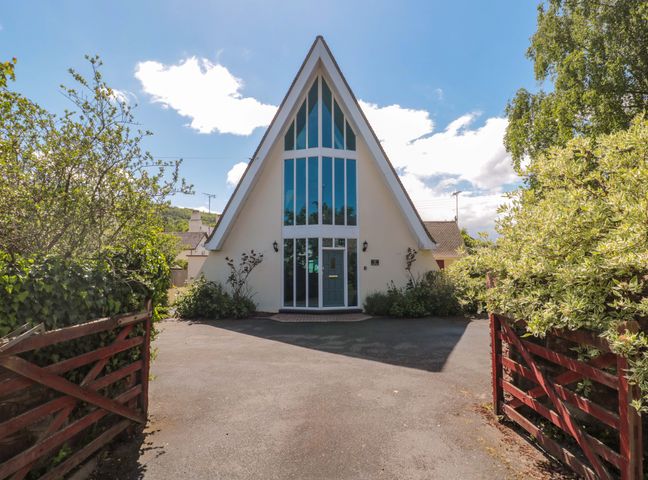 A house with large windows and a driveway at Lady Of Lourdes in Whitchurch, Herefordshire