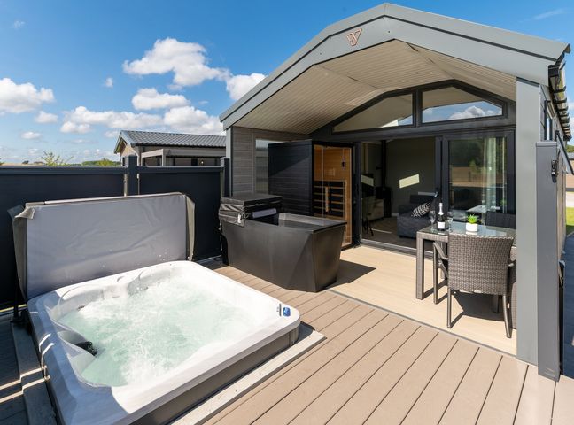 An outdoor area with a hot tub and seating at The Oasis in Great Ayton