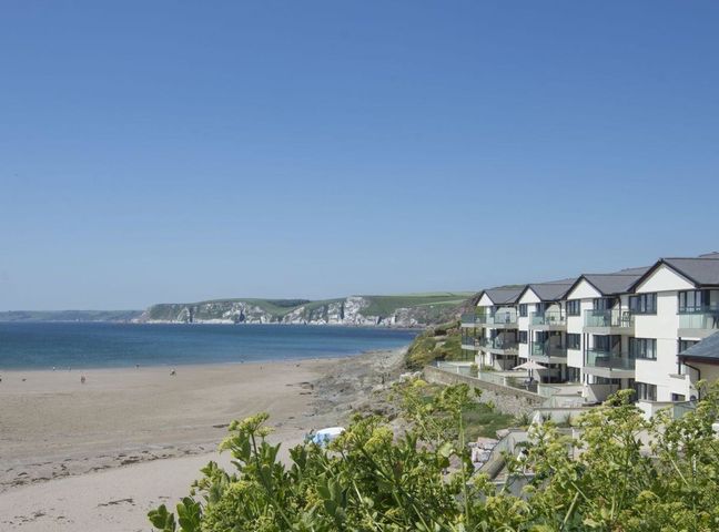 A view of a beach and apartment building at 2 Burgh Island Causeway Kingsbridge