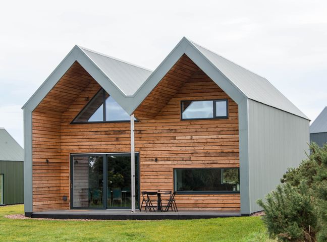 A modern house with a wooden exterior and large windows at The Laidlaw Spa in North Berwick