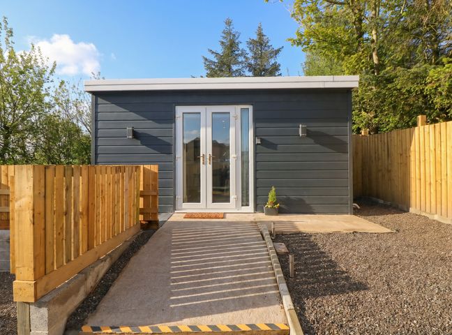 An outdoor view of a cabin entrance at Heidiaway Lodge in Gilfach Goch
