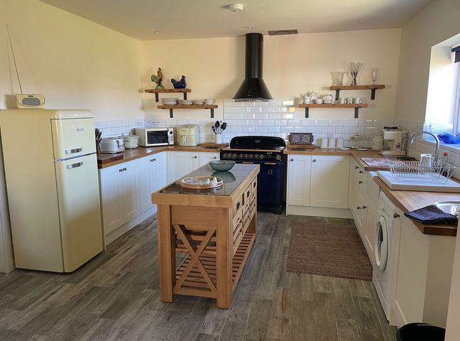 A kitchen with refrigerator, oven, and kitchen island at Country Retreat Sleeps 2 Holyhead