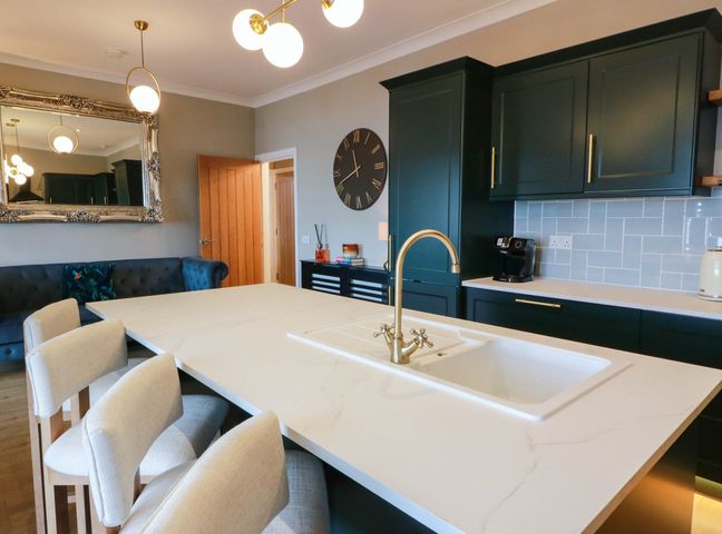 A kitchen with a sink and island at Flat 1 86 Gallowgate Street Largs