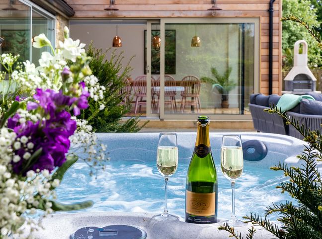 A hot tub with champagne and glasses at 2 The Croft in Skipton