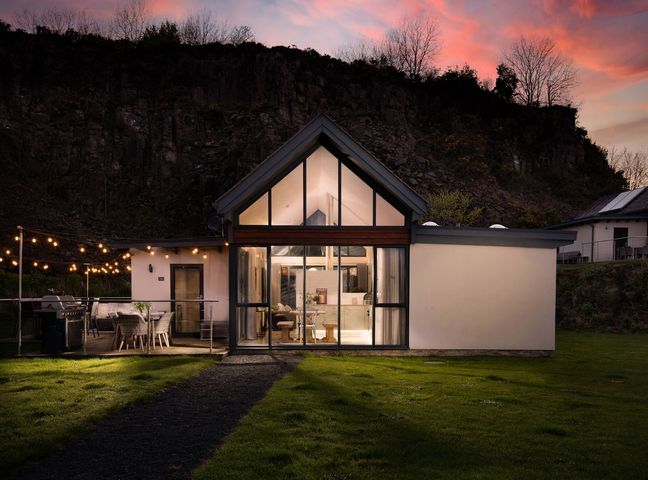 A house with a deck and garden at Summerset Lodge