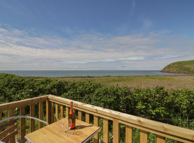 Outdoor area with a table and champagne overlooking the sea at The Swift in St Bees