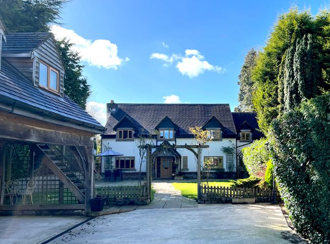 A house with a driveway and garden at The Oaks in Great Harwood