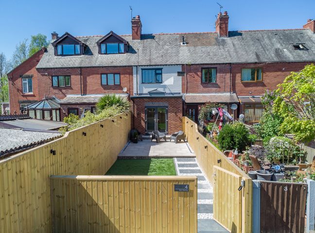 A garden with a pathway and seating area at 4 Bryn Heulog in Wrexham